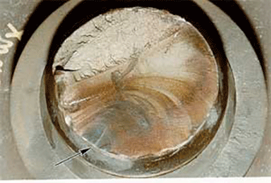 Figure 2: A view of the fractured shaft. The “beach marks” indicated by the arrow are characteristic of fatigue-related failure.
