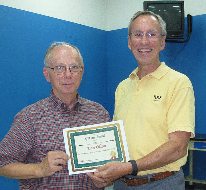 Jeff presenting an award to Dan Olson.