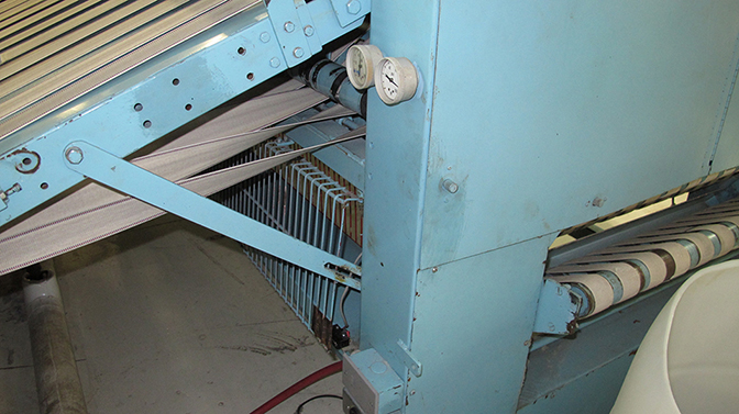 A desk review concluded that the folding machine, while safeguarded, contained a condition of defect that put workers at risk. The defect was a hinged grate that was not interlocked because the employer had failed to maintain the safety switch on the hinged grate below the folding machine. The manufacturer intended for the switch to stop the machine whenever the hinged grate was opened.