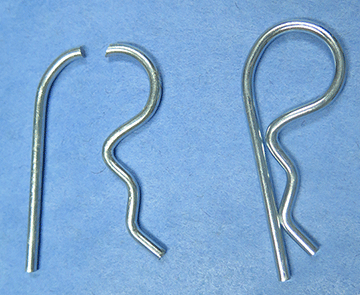 A fractured spring clip pictured with an intact clip.